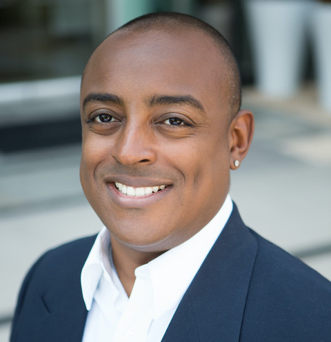 Portrait of Rick Smith smiling and wearing a dark jacket