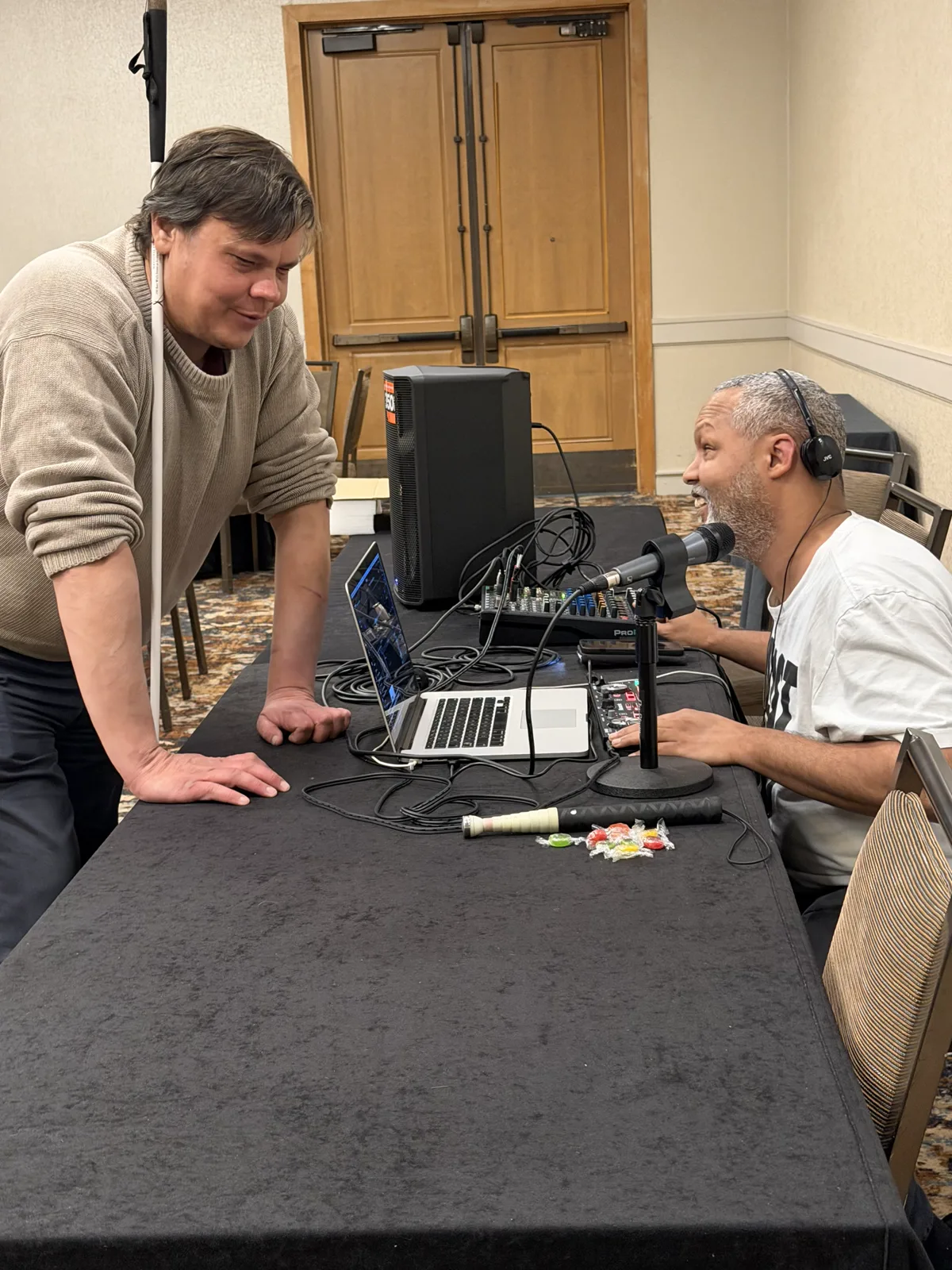 Clarence Griffin demonstrates blind DJing with a laptop, controller, headphones, and microphone.