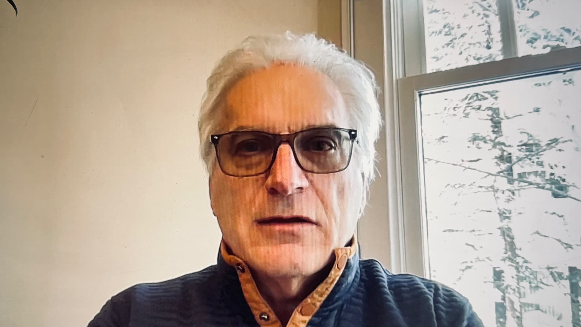 Portrait of Bob Lasandrello wearing glasses near a window